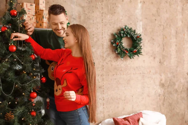 Happy couple decorating Christmas tree at home — Stock Photo, Image