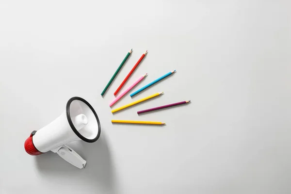 Megaphone with colorful pencils on white background — Stock Photo, Image