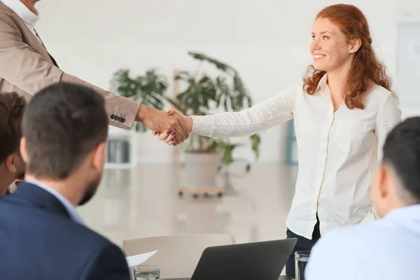 Young business people shaking hands during meeting in office — Stock Photo, Image