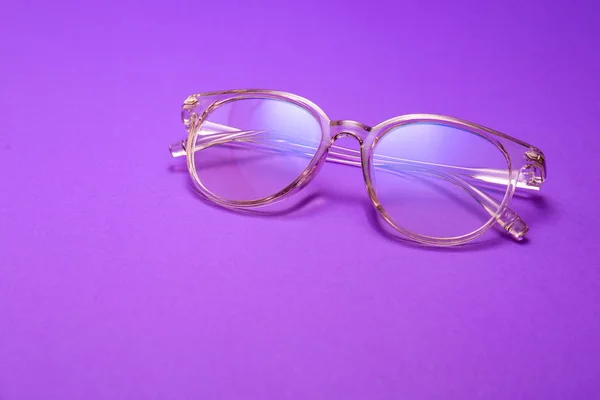 Stylish eyeglasses on color background — Stock Photo, Image