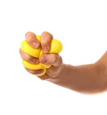 Hand squeezing stress ball on white background