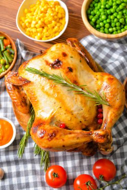 Tasty baked turkey and different food for Thanksgiving day on table
