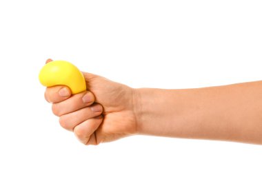 Hand squeezing stress ball on white background