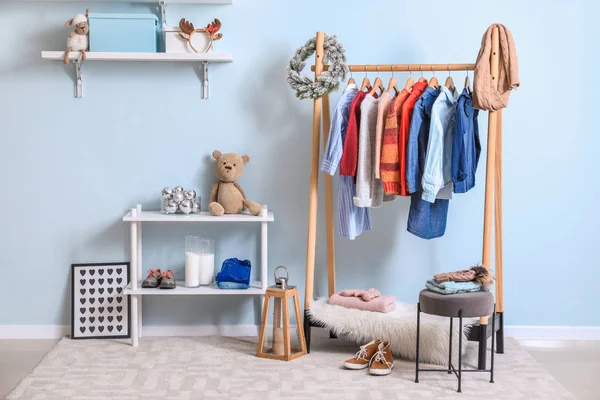 Interior of modern dressing room with winter clothes