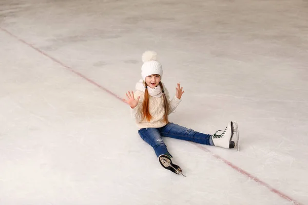 Cute little girl after falling on skating rink — Stock Photo, Image