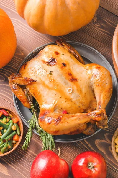 Tasty baked turkey and different food for Thanksgiving day on table