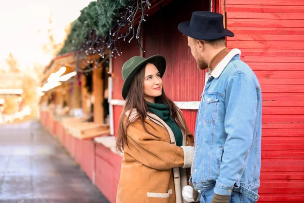 Happy young couple on Christmas fair outdoors — Stock Photo, Image