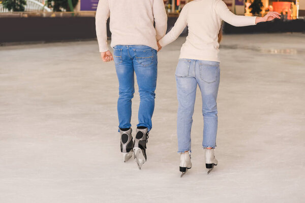 Young couple on skating rink