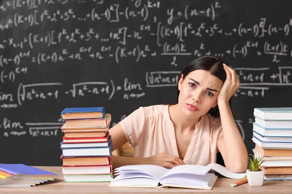 Müde Lehrerin am Tisch im Klassenzimmer — Stockfoto