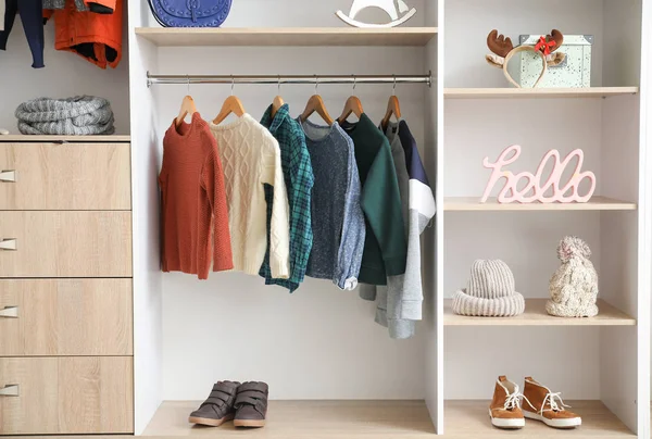 Modern wardrobe with stylish winter clothes and accessories — Stok fotoğraf