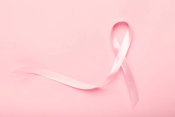 Pink ribbon on color background. Breast cancer awareness concept — Stock Photo, Image