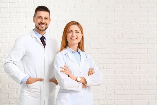 Equipe de médicos em fundo de tijolo branco — Fotografia de Stock