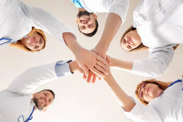 Team of doctors putting hands together, bottom view — 스톡 사진