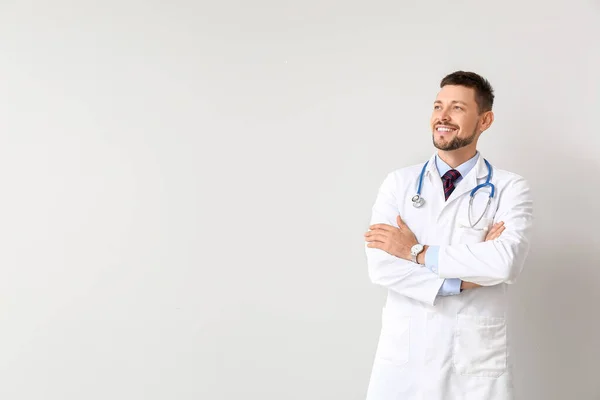 Portrait of male doctor on light background — Stock Photo, Image