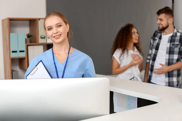 Young female receptionist at desk in clinic — Stock Photo, Image