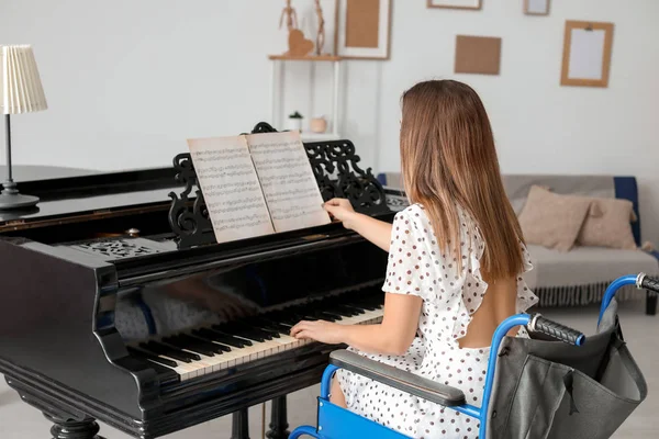 Young woman in wheelchair playing grand piano at home — Stock Photo, Image