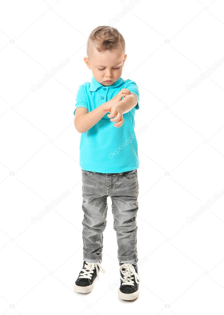 Scratching allergic little boy on white background