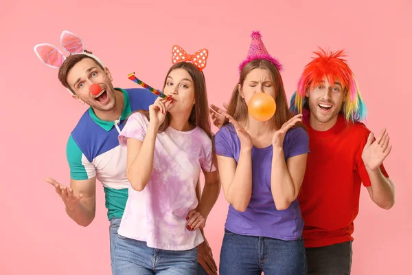 People in funny disguise on color background. April fools' day celebration — Stock Photo, Image