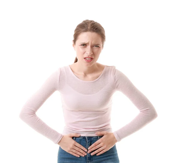 Wanita muda yang menderita sakit perut pada latar belakang putih — Stok Foto
