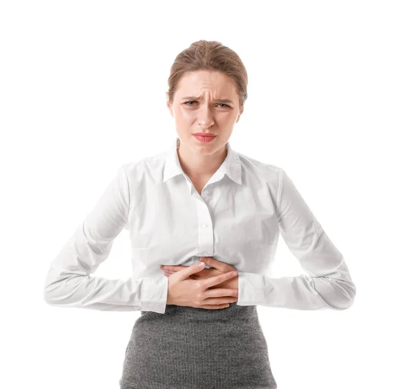 Young businesswoman suffering from abdominal pain on white background — 스톡 사진
