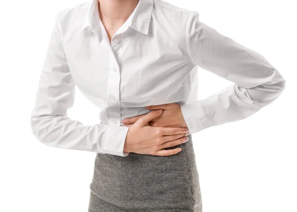 Young businesswoman suffering from abdominal pain on white background — 스톡 사진