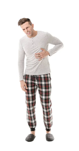 Mladý muž trpící bolesti břicha na bílém pozadí — Stock fotografie