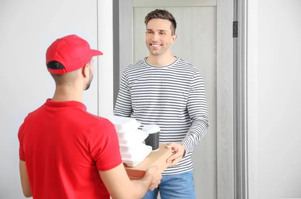 Man receiving order from courier of food delivery company