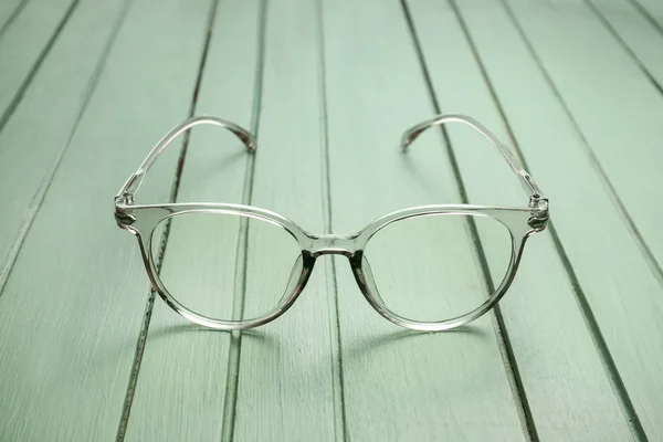 Elegantes gafas graduadas sobre mesa de madera — Foto de Stock