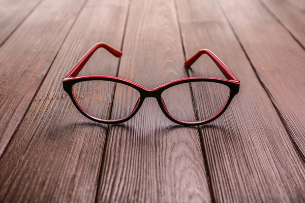 Stílusos szemüveg a fa asztalon — Stock Fotó