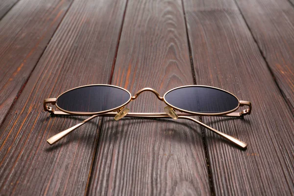Elegantes gafas de sol sobre mesa de madera — Foto de Stock