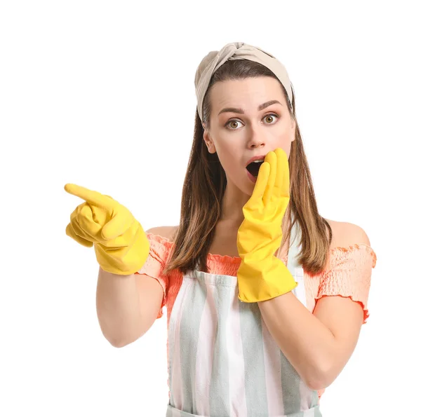 Surprised young housewife pointing at something on white background — Stock Photo, Image