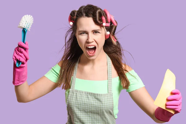 Crazy young housewife on color background — Stock Photo, Image