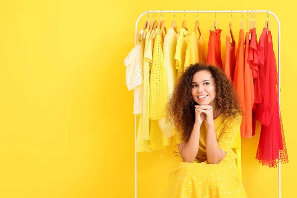 African-American stylist near rack with modern clothes — Stock Photo, Image