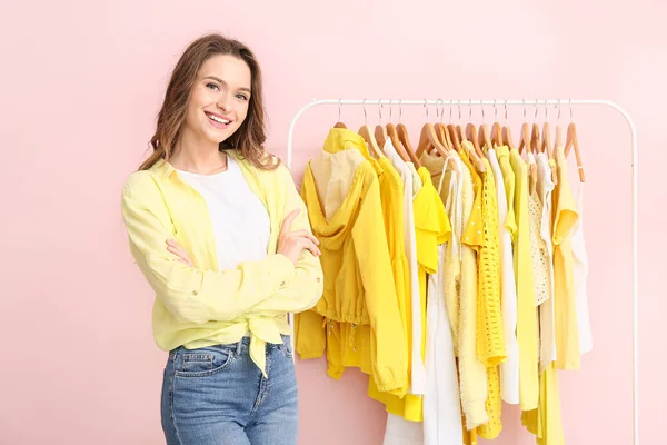 Female stylist near rack with modern clothes — Stock Photo, Image