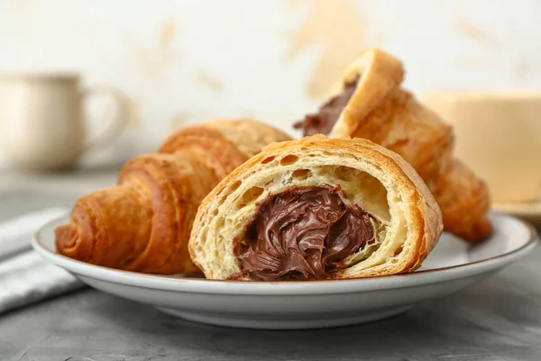 Plate with tasty sweet croissants on table — Stock Photo, Image