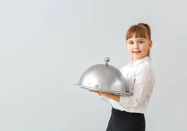 Cute little waiter on light background — Stock Photo, Image