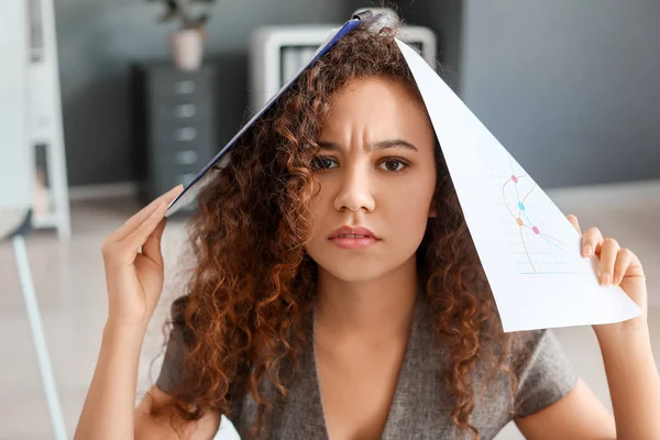 Tired African-American businesswoman working in office — Stock Photo, Image