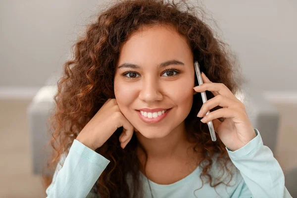 Jovem afro-americana conversando por telefone em casa — Fotografia de Stock