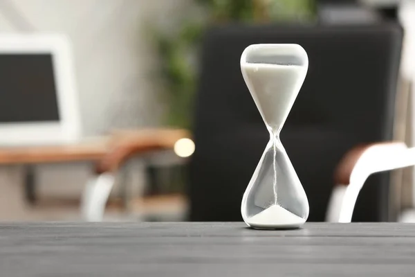 Hourglass on table in office. Time management concept — Stock Photo, Image