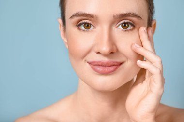 Renkli, sağlıklı cilde sahip güzel genç bir kadın.