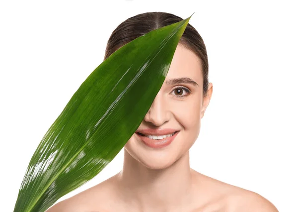 Beautiful young woman with healthy skin and tropical leaf on white background — Stock Photo, Image