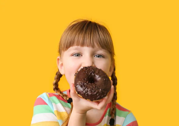 Funny little girl with donut on color background — Stock Photo, Image