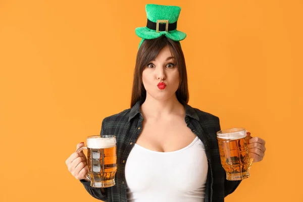 Funny young woman with beer on color background. St. Patrick\'s Day celebration