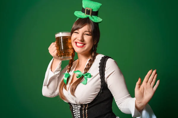 Funny young woman with beer on color background. St. Patrick\'s Day celebration