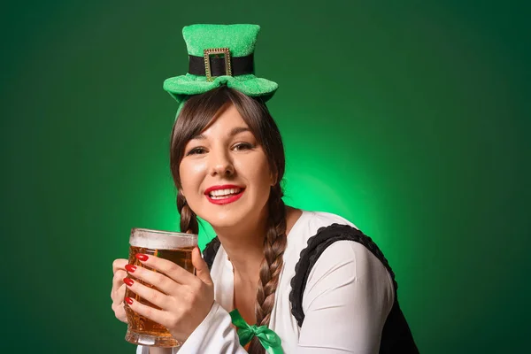 Funny young woman with beer on color background. St. Patrick\'s Day celebration