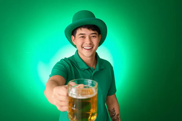 Young Asian man with beer on color background. St. Patrick's Day celebration — 스톡 사진