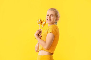 Beautiful young woman with party decor on color background. International Women's Day celebration
