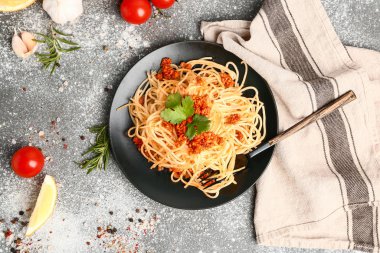 Plate with tasty pasta bolognese on grey background