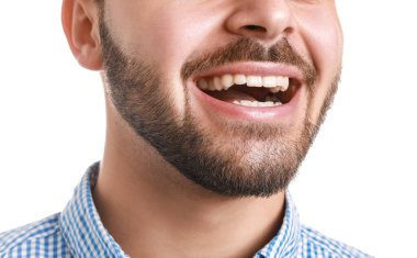 Handsome smiling young man on white background, closeup