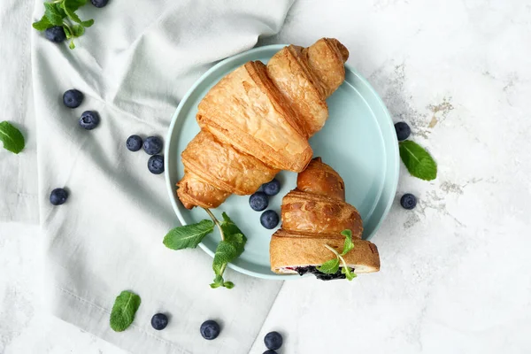 Plate with tasty sweet croissants on white background — Stock Photo, Image